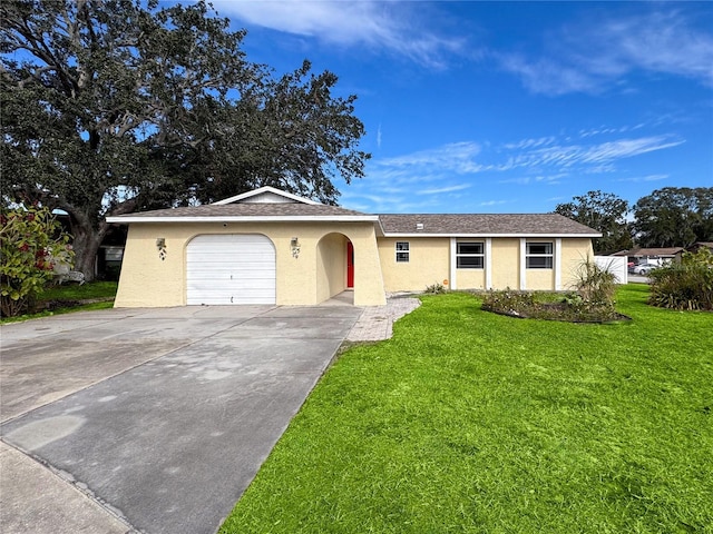 single story home featuring a garage and a front lawn