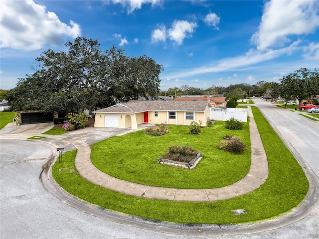 ranch-style home featuring a front yard and a garage