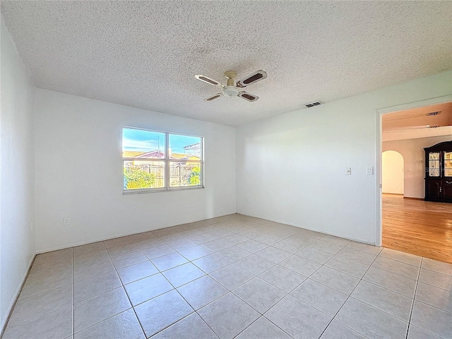 tiled spare room featuring ceiling fan and a textured ceiling