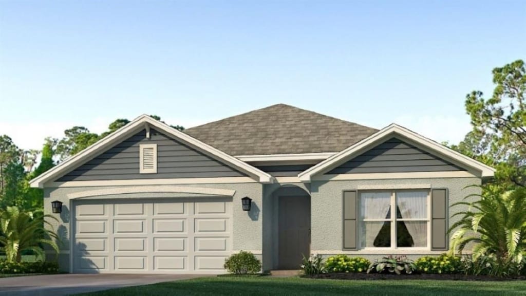 view of front of home featuring a garage and a front lawn