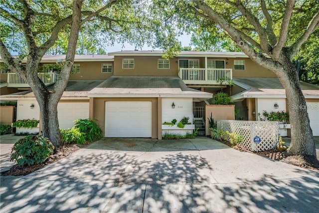 townhome / multi-family property with a balcony and a garage