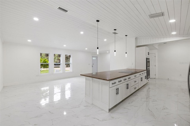 kitchen with hanging light fixtures, black electric cooktop, double oven, white cabinetry, and wood ceiling