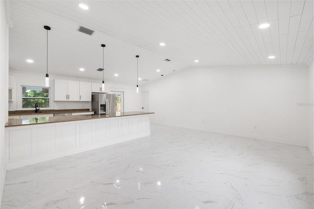 kitchen with white cabinetry, stainless steel fridge with ice dispenser, sink, and pendant lighting