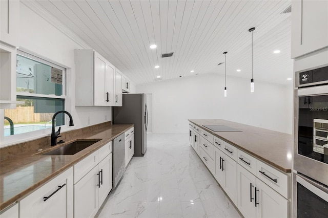 kitchen featuring sink, appliances with stainless steel finishes, decorative light fixtures, white cabinetry, and wood ceiling