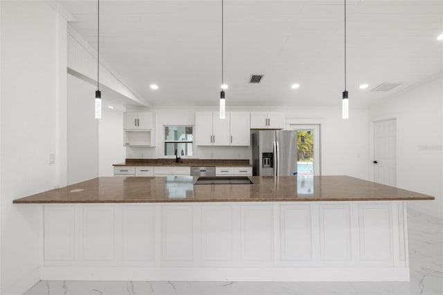 kitchen with decorative light fixtures, dark stone countertops, white cabinetry, and stainless steel appliances