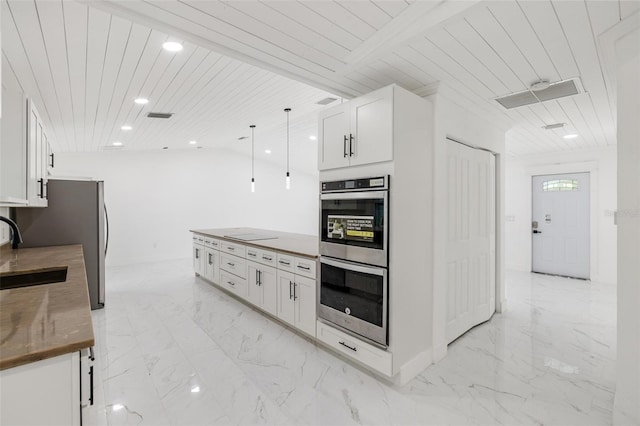 kitchen featuring white cabinets, wooden ceiling, stainless steel appliances, and hanging light fixtures