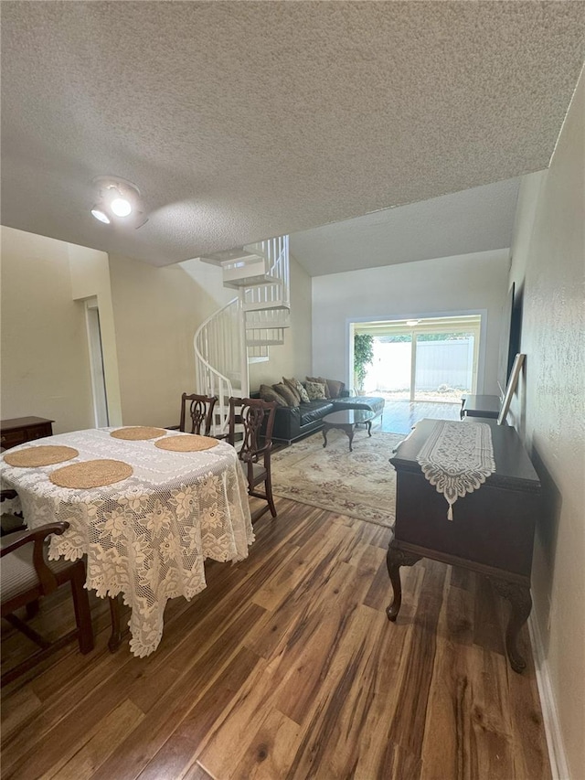 dining room featuring hardwood / wood-style floors and a textured ceiling