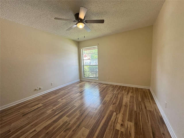 spare room featuring a textured ceiling, dark hardwood / wood-style floors, and ceiling fan