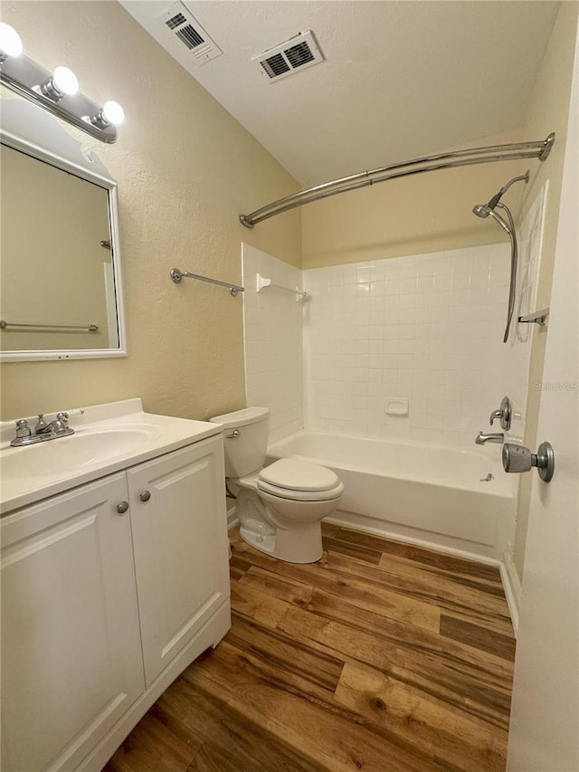 full bathroom featuring shower / bathing tub combination, hardwood / wood-style floors, vanity, and toilet