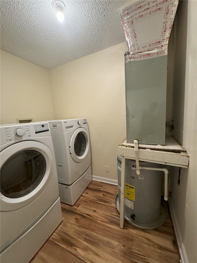 washroom featuring wood-type flooring, a textured ceiling, and washing machine and clothes dryer