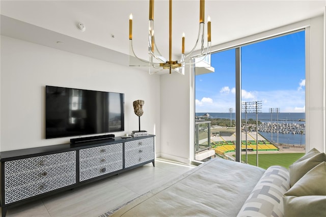 bedroom with a chandelier, multiple windows, expansive windows, and concrete floors