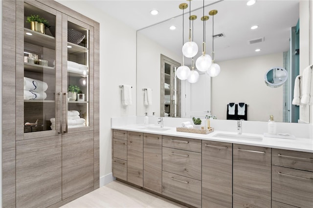 bathroom featuring a shower, vanity, and tile patterned flooring