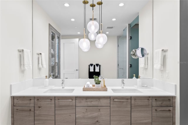 bathroom featuring vanity and a shower with door