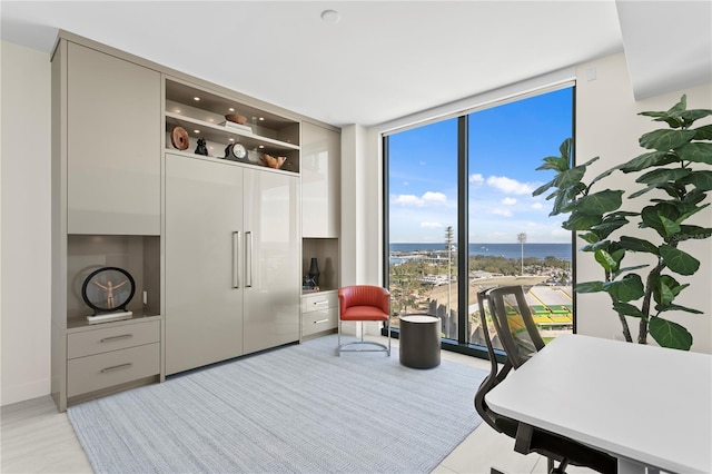 office area with a water view and floor to ceiling windows