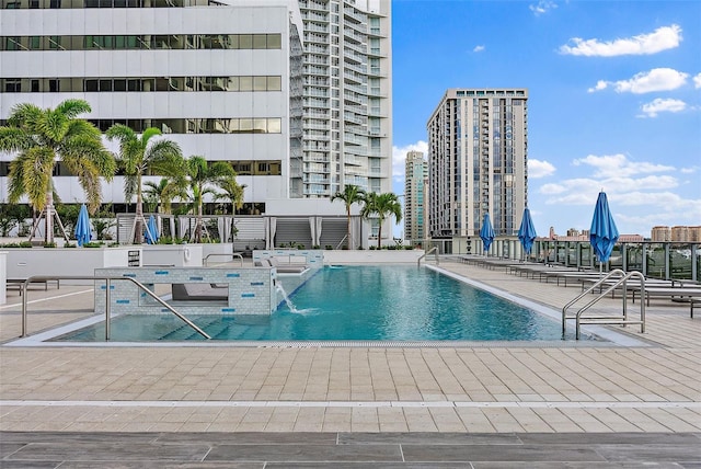 view of pool with pool water feature and a patio