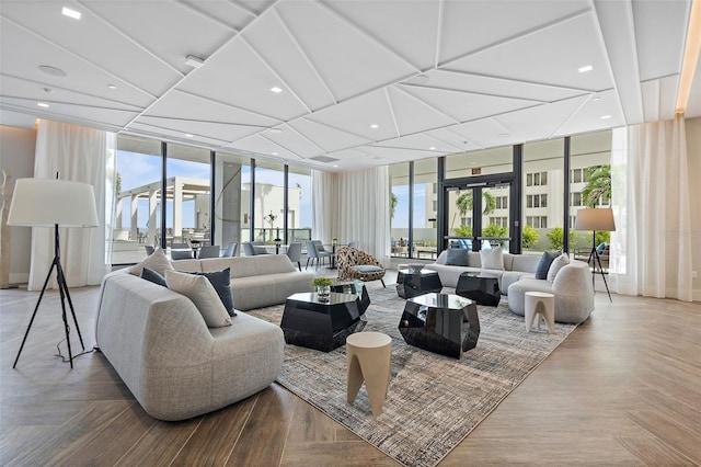 living room with parquet floors, french doors, and a wall of windows