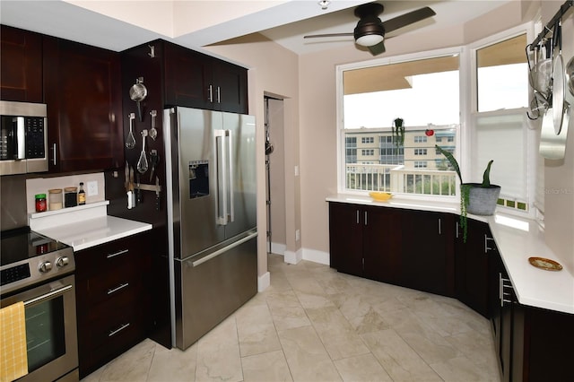 kitchen featuring appliances with stainless steel finishes, dark brown cabinets, plenty of natural light, and ceiling fan