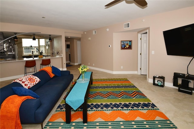 living room with ceiling fan and sink