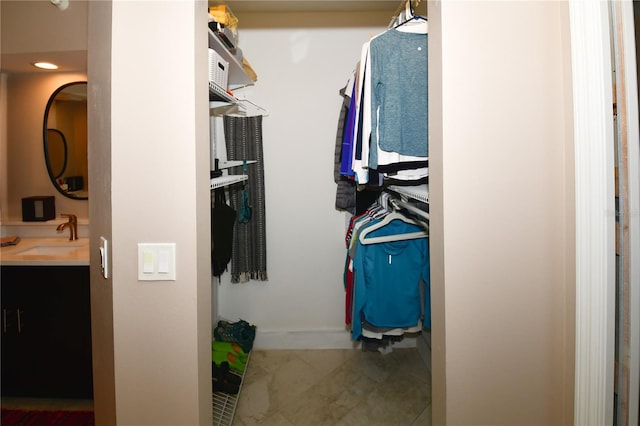 spacious closet with tile patterned flooring and sink