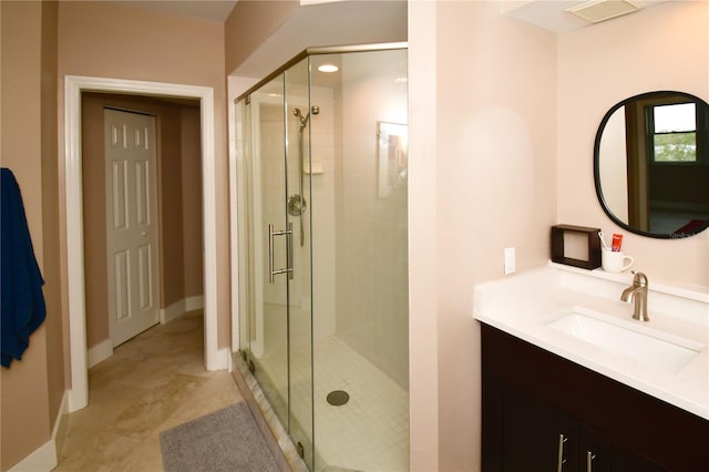 bathroom featuring vanity, tile patterned floors, and an enclosed shower