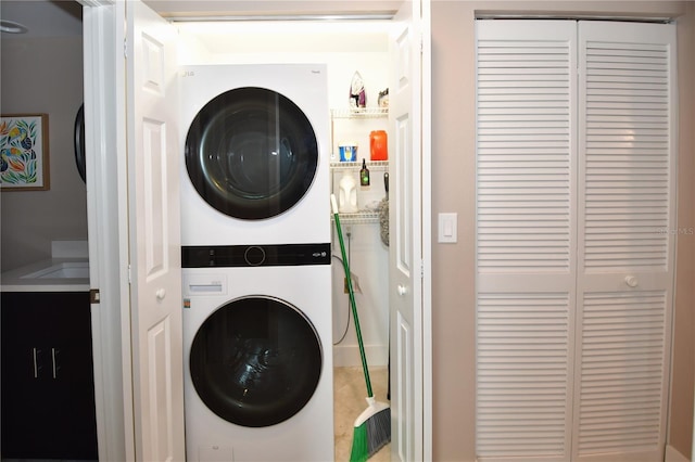 laundry area with stacked washer / drying machine