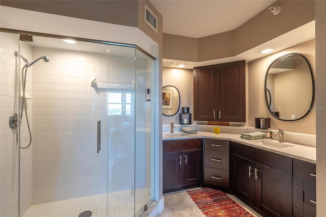 bathroom with tile patterned flooring, vanity, and an enclosed shower