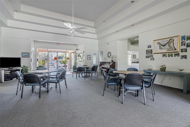 dining area with a high ceiling and ceiling fan