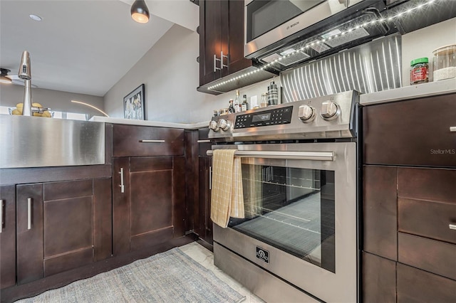 kitchen featuring stainless steel appliances and dark brown cabinets