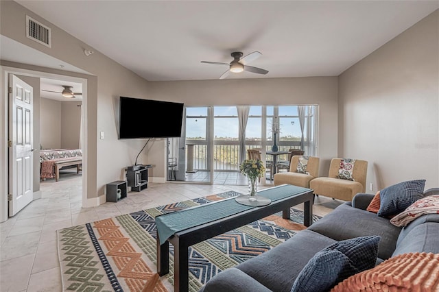 living room featuring light tile patterned floors and ceiling fan