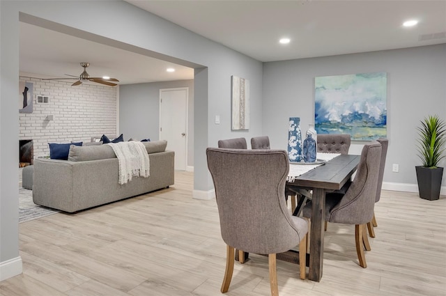 dining room with ceiling fan and light hardwood / wood-style floors