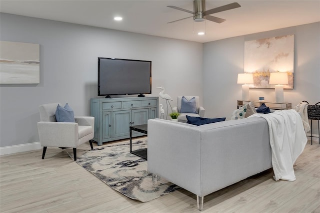 living room featuring light hardwood / wood-style floors and ceiling fan