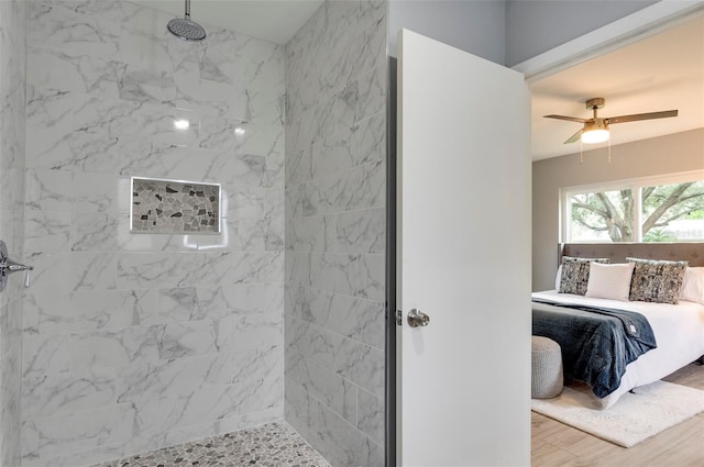 bathroom featuring ceiling fan, hardwood / wood-style floors, and tiled shower