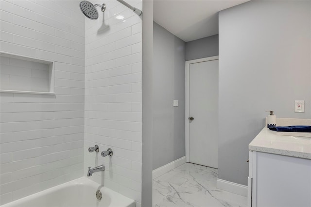 bathroom featuring vanity and tiled shower / bath