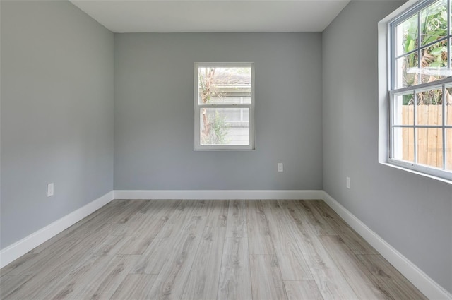 unfurnished room with light wood-type flooring