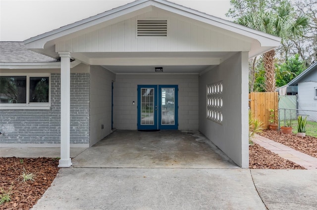 view of exterior entry with a carport