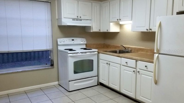 kitchen featuring sink, white appliances, light tile patterned floors, and white cabinets