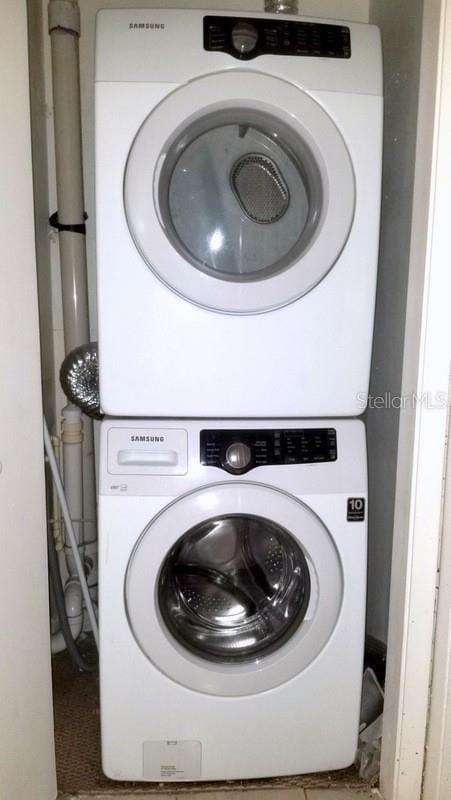 clothes washing area with stacked washer / drying machine