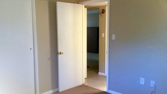 corridor featuring light colored carpet