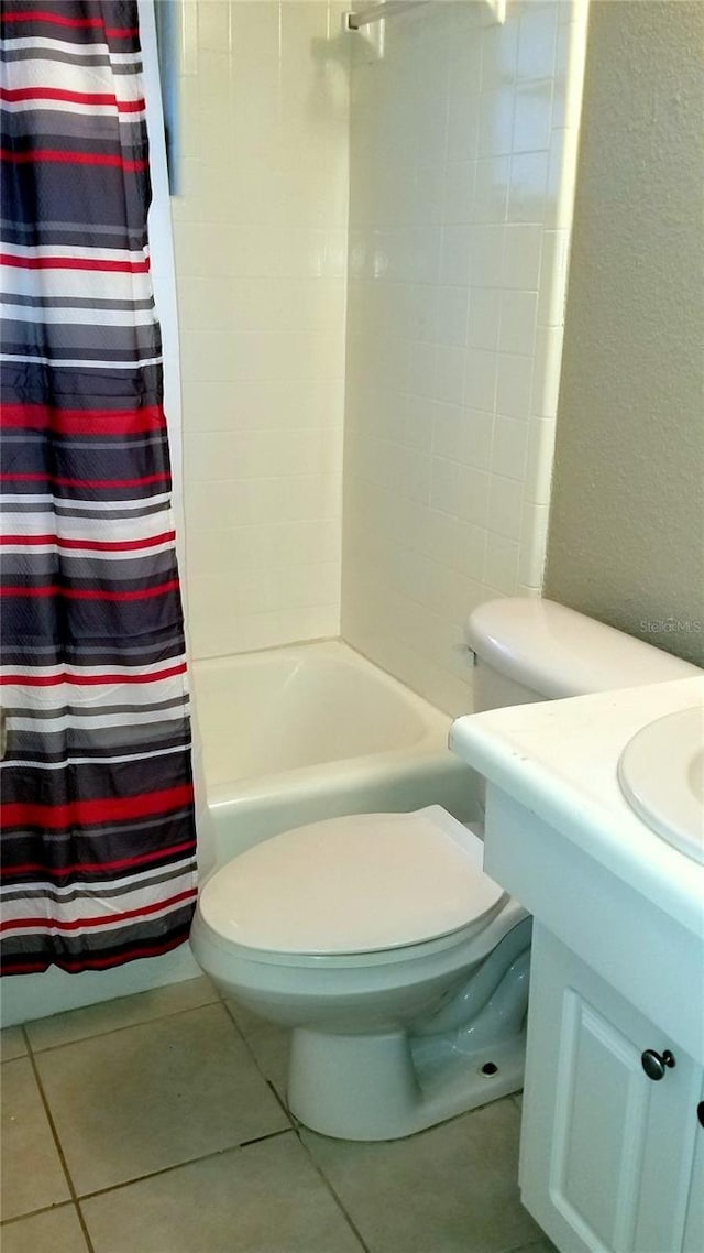 full bathroom featuring shower / tub combo, vanity, toilet, and tile patterned flooring