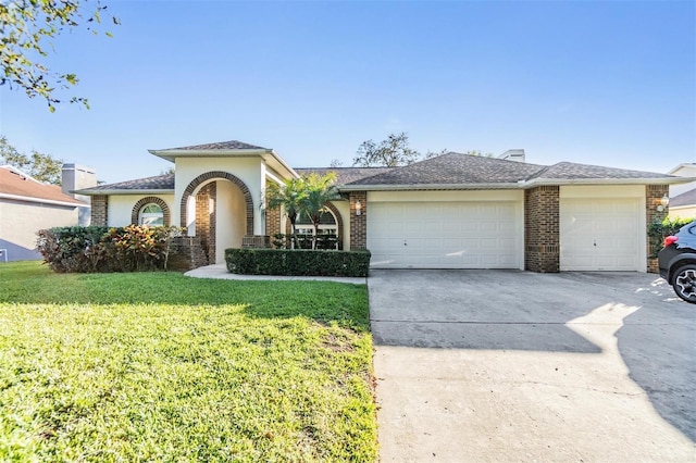 view of front of home featuring a garage and a front lawn