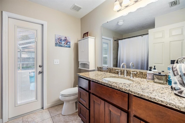 bathroom with tile patterned floors, vanity, and toilet