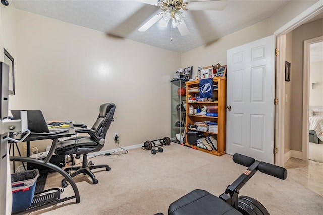 exercise room with ceiling fan and carpet floors