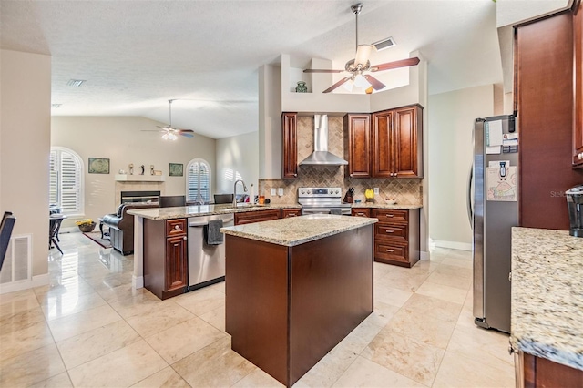 kitchen featuring kitchen peninsula, appliances with stainless steel finishes, light stone countertops, wall chimney range hood, and lofted ceiling