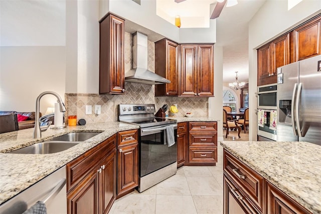 kitchen with appliances with stainless steel finishes, light stone counters, wall chimney exhaust hood, and sink