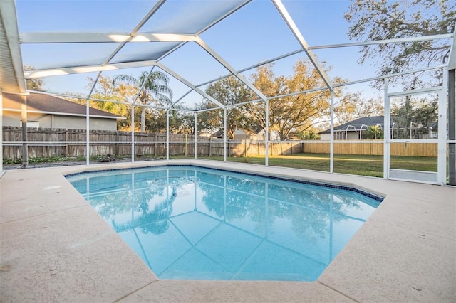 view of swimming pool with a patio area, a lanai, and a lawn