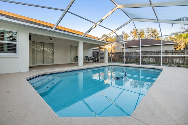 view of pool featuring a lanai, ceiling fan, and a patio area