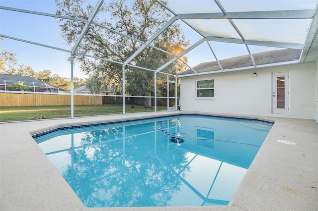 view of swimming pool with a lawn, glass enclosure, and a patio