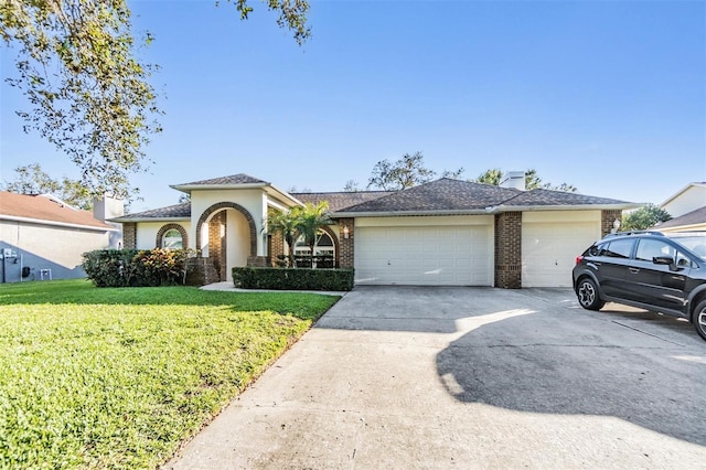 view of front of house featuring a garage and a front lawn