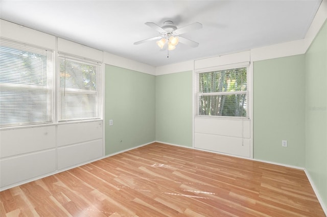 empty room with hardwood / wood-style flooring and ceiling fan