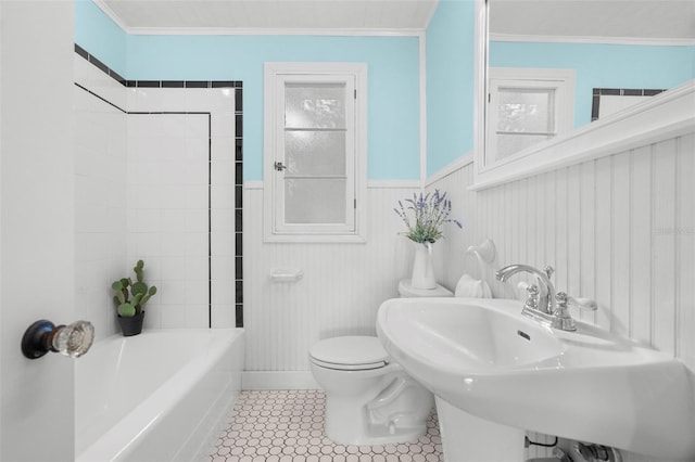 bathroom featuring tile patterned flooring, ornamental molding, sink, and toilet